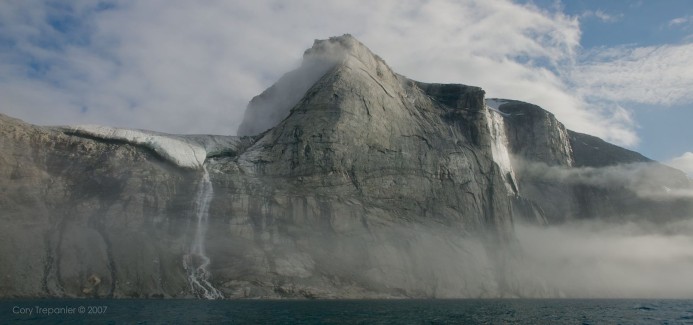 As we entered further into Sam Ford Fiord, the massive rock walls emerged from the fog and revealed glaciers and waterfalls. This fiord differed from Coronation further to the south in that there is a lot of sheer solid rock jutting, in many cases, straight out of the water, rising up for thousands of feet.