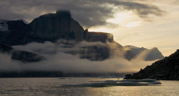 Fog moves in under the evening light.