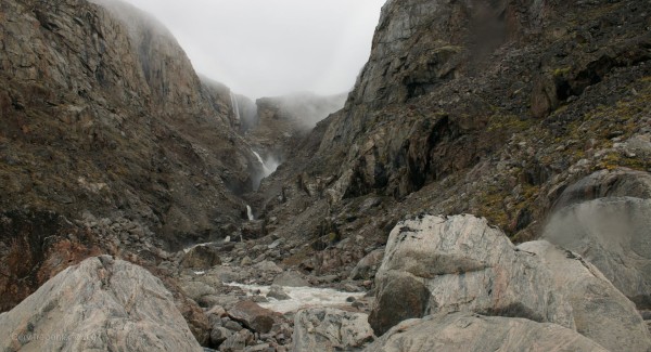 A gorgeous waterfall cascading down the hill.